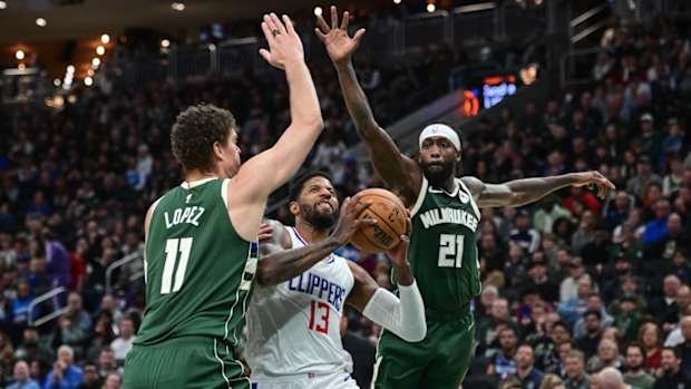 Los Angeles Clippers forward Paul George (13) takes a shot between Milwaukee Bucks center Brook Lopez (11) and guard Patrick Beverley (21) in the second quarter at Fiserv Forum in Milwaukee on March 4, 2024.